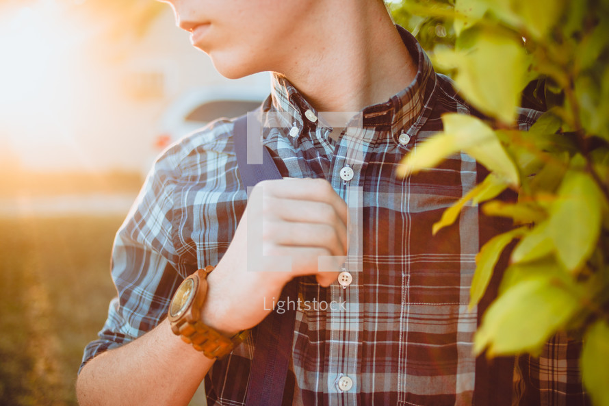 torso of teen boy in a plaid shirt 