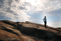 a man standing on a rocky slope
