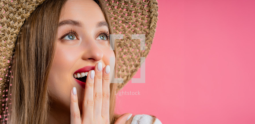 Amazed woman, she expresses WOW. Impressed teenager trying to get attention. Concept of sales, profitable offer. Excited romantic girl on pink background. High quality 