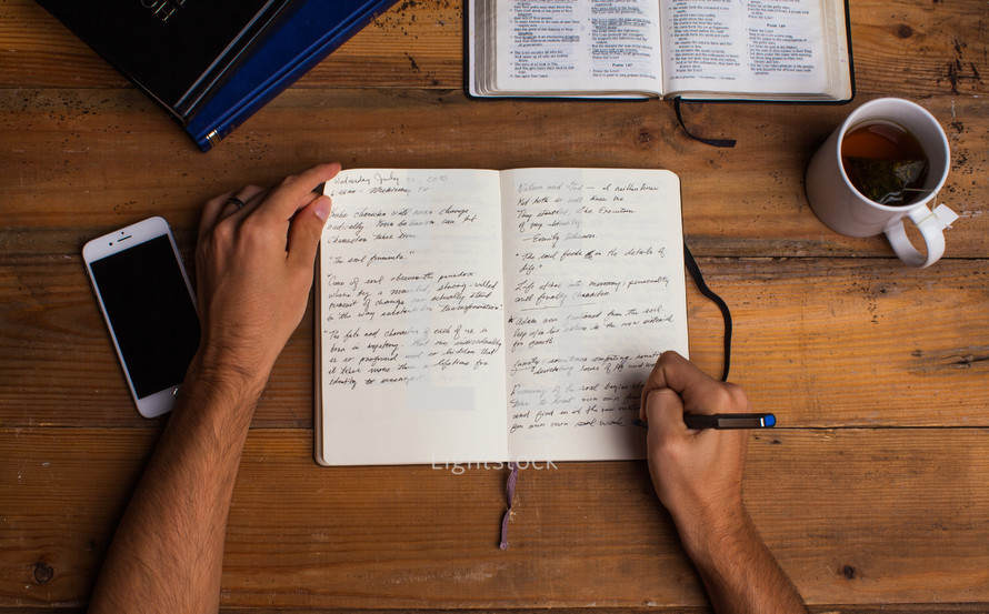  man writing in a journal, Bible study
