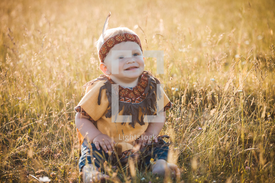 Happy Cute Smiling Little Boy dressed in Native American Apache Clothes
