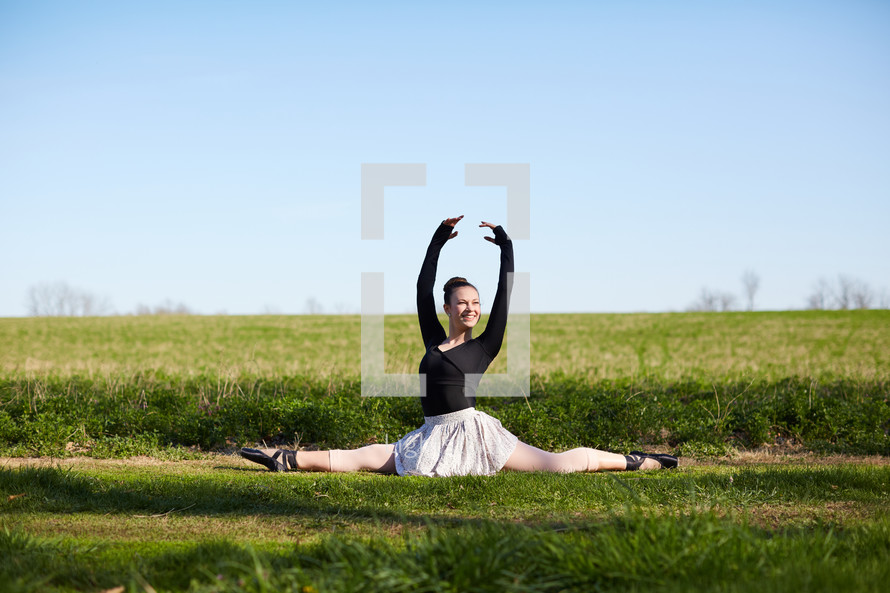 a ballerina in a field 