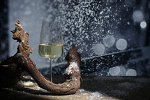 Closeup Glass of White Wine and snow at Winter Window