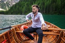 a man paddling a rowboat 