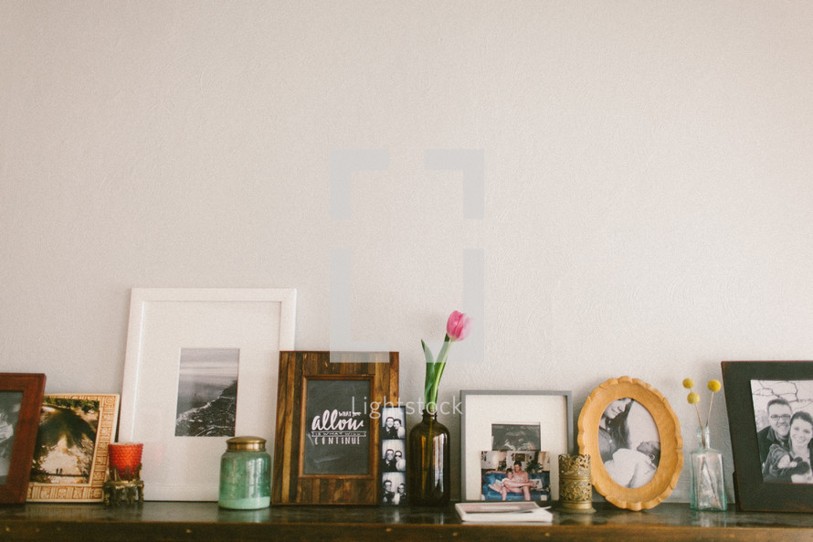 framed pictures on a mantle