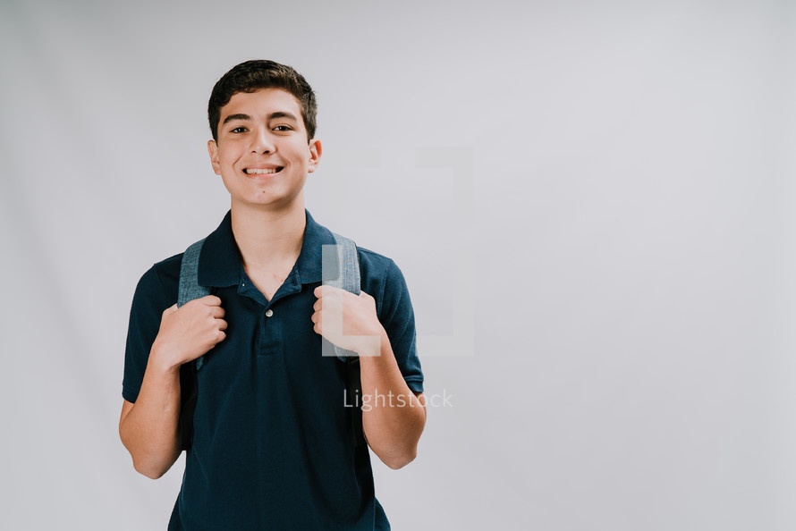a teen boy with a book bag 