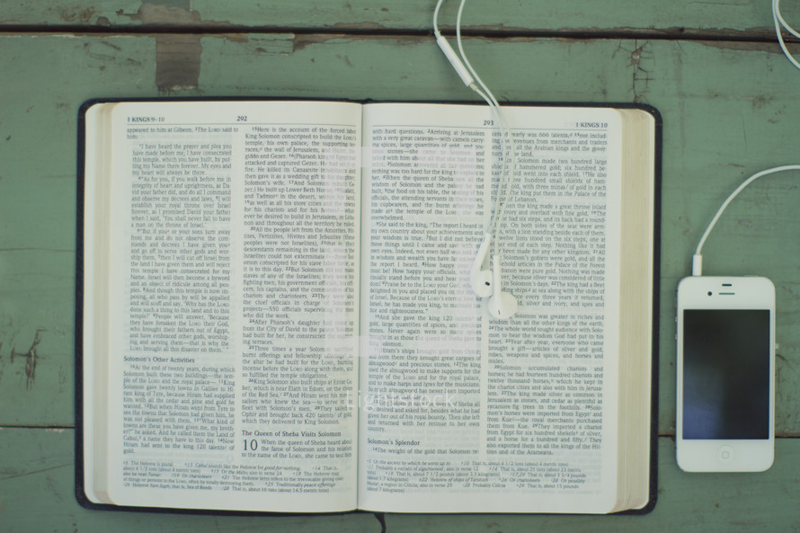 open Bible and iPhone and earbuds 