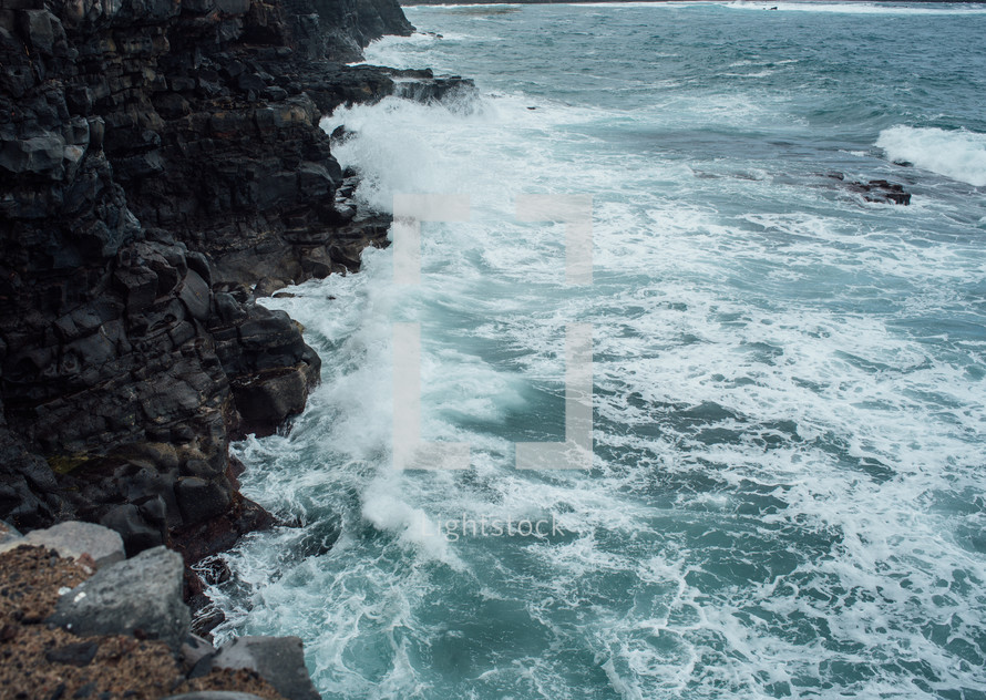 Waves crashing against the cliffs
