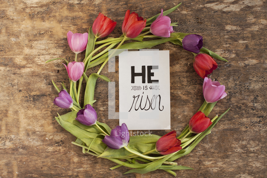 Ring of tulips surrounding a "He is risen" card.