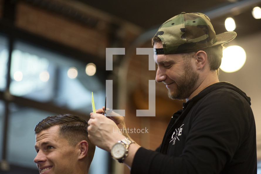 Man getting a haircut at parlor.