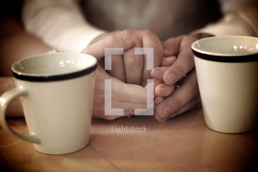 holding hands and coffee mugs 