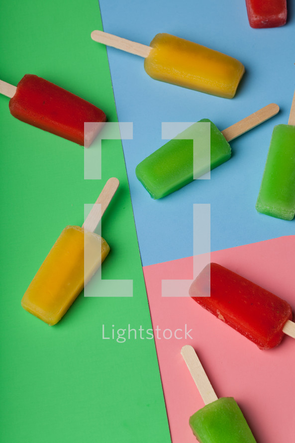 Brightly colored popsicles on a multi-colored background.