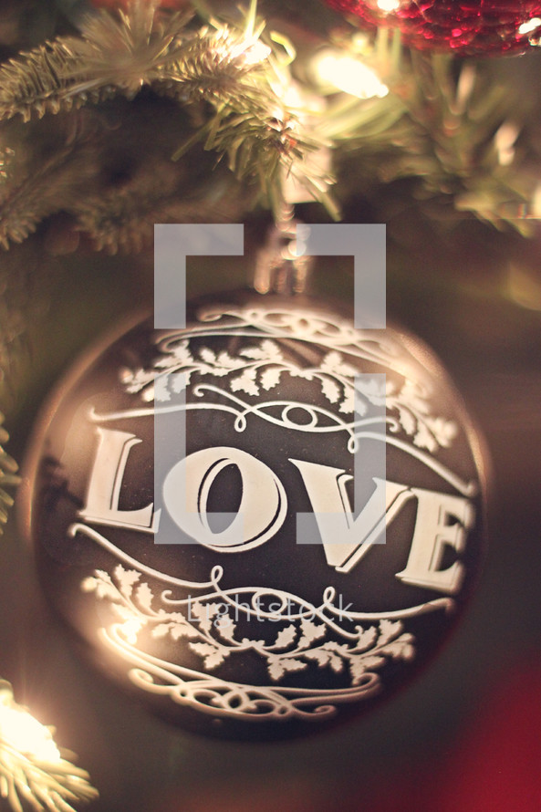love Christmas ornament on a Christmas tree