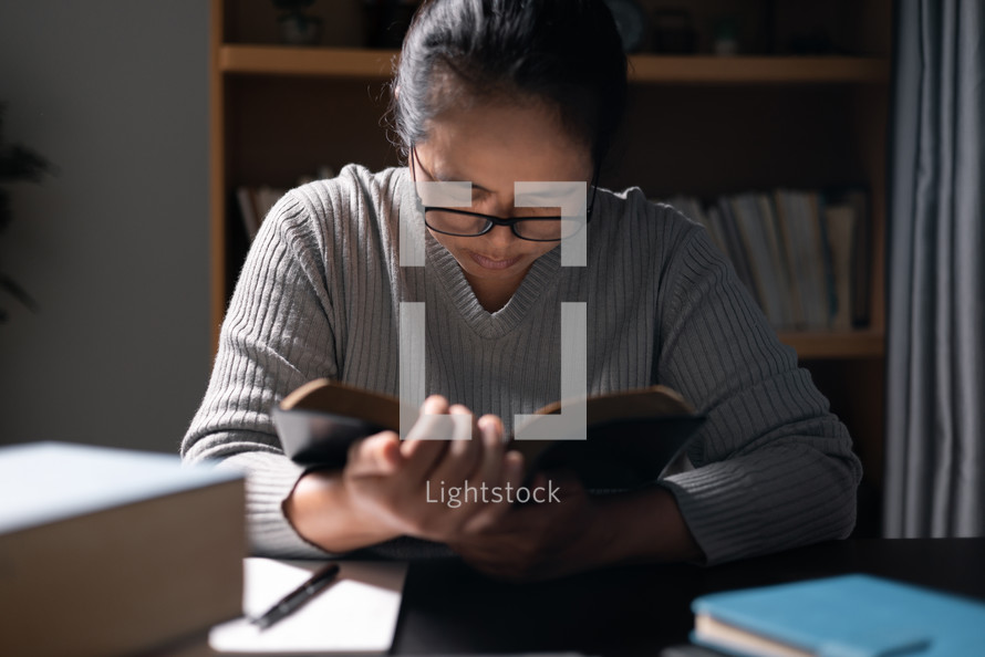 Woman praying with a Bible