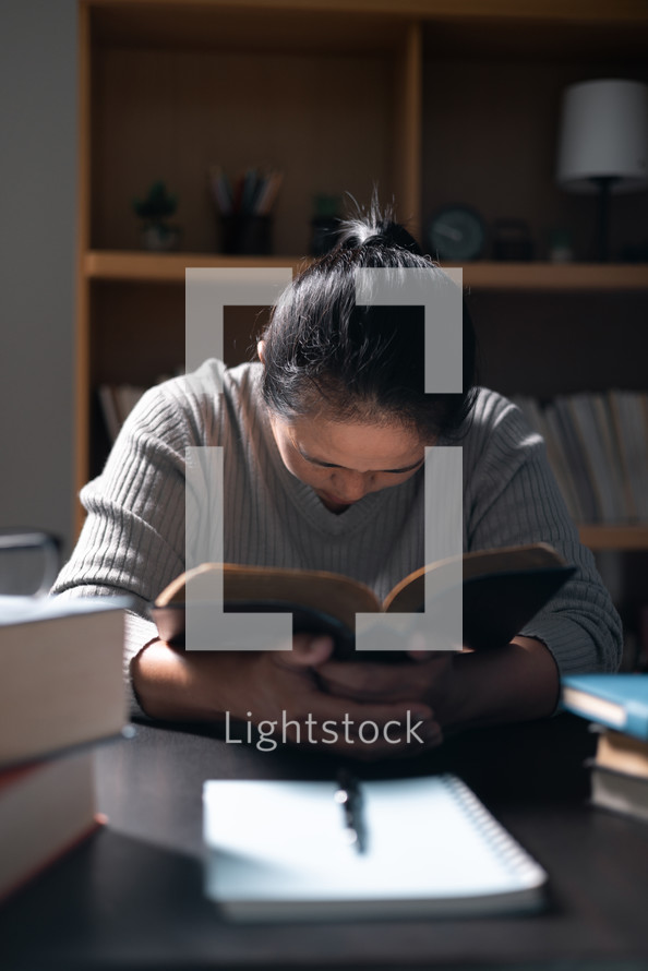 Woman praying with a Bible