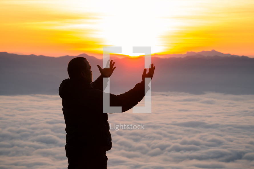 Man raising hands to the heavens 