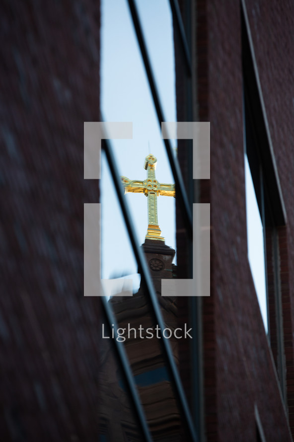 cross topper on a church roof 