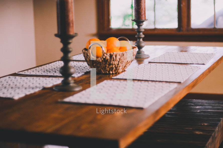 basket of oranges as a centerpiece on a dining room table 