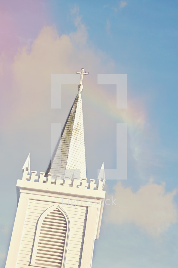 white church steeple and rainbow 