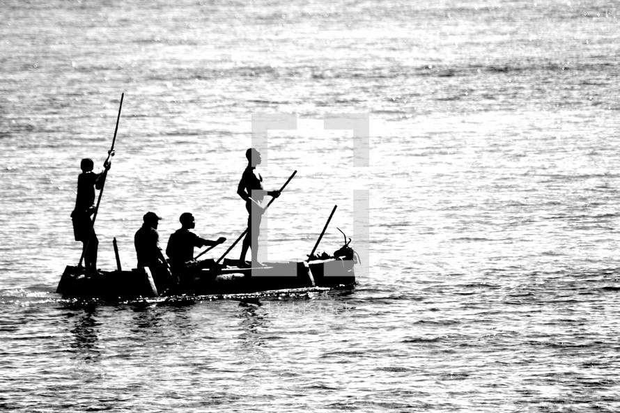 four fisherman on a canoe 
