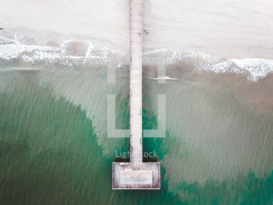 aerial view over an ocean pier 