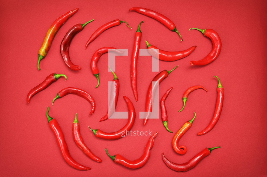 Red peppers on red background