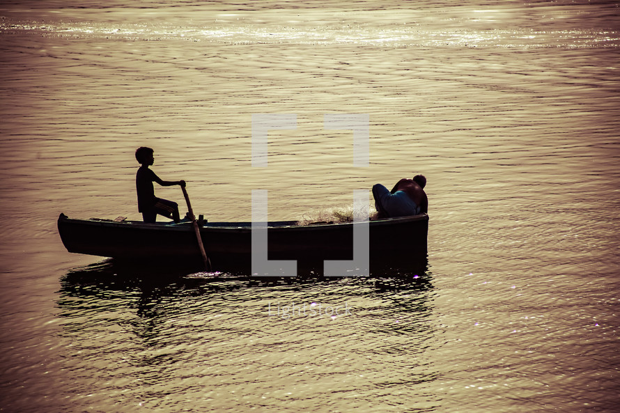 a child rowing a fishing boat 