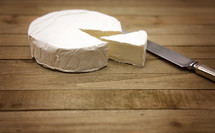 White Round of Soft Cheese on a Wooden Table