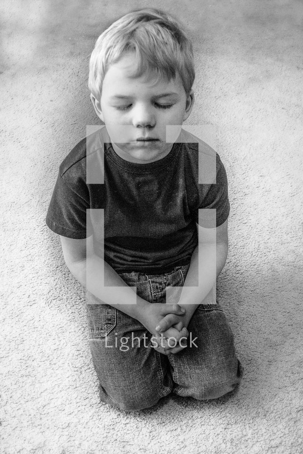 toddler kneeling in prayer 