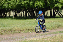 Active child wearing bike helmet riding a bike 