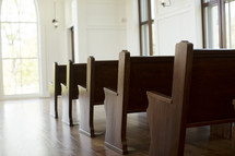 rows of empty pews in a church 
