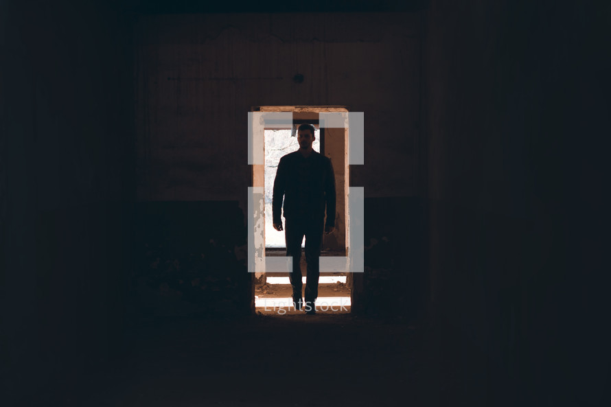 a man walking through a doorway 