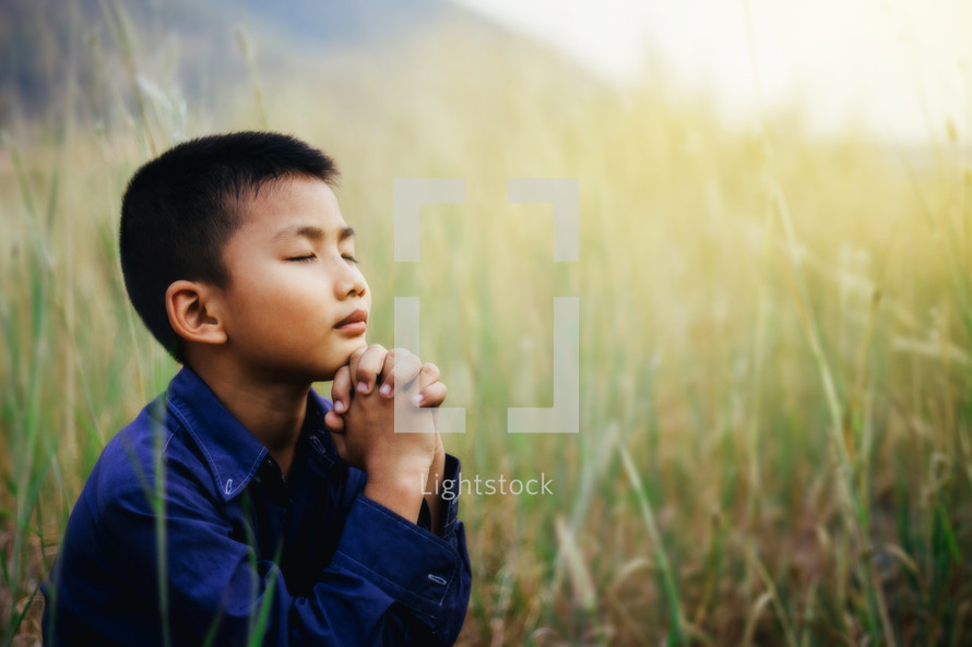 boy with praying hands 