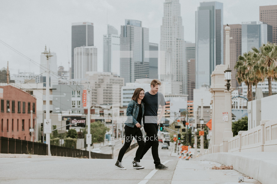 couple walking in a city with palm trees 
