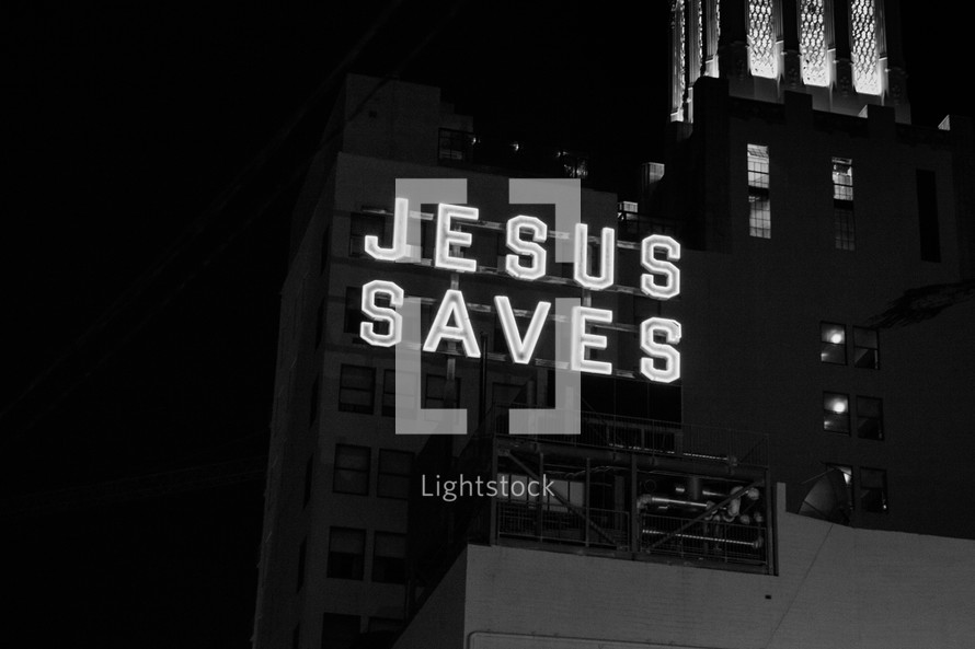 Jesus saves sign in a city at night 
