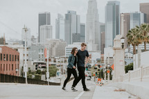 couple walking in a city with palm trees 