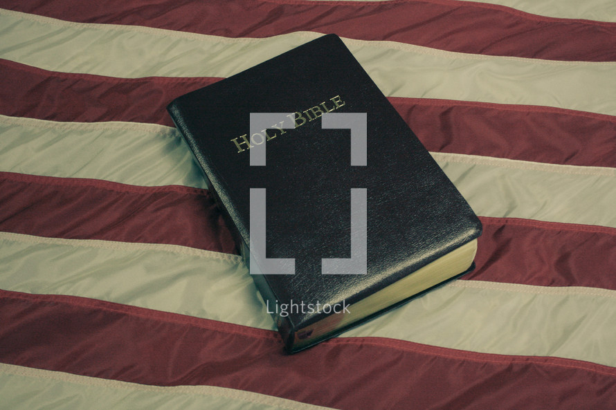 Holy Bible on American flag with retro effect.