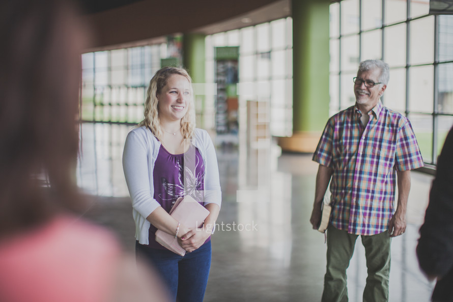 conversations in a church narthex before a worship service 