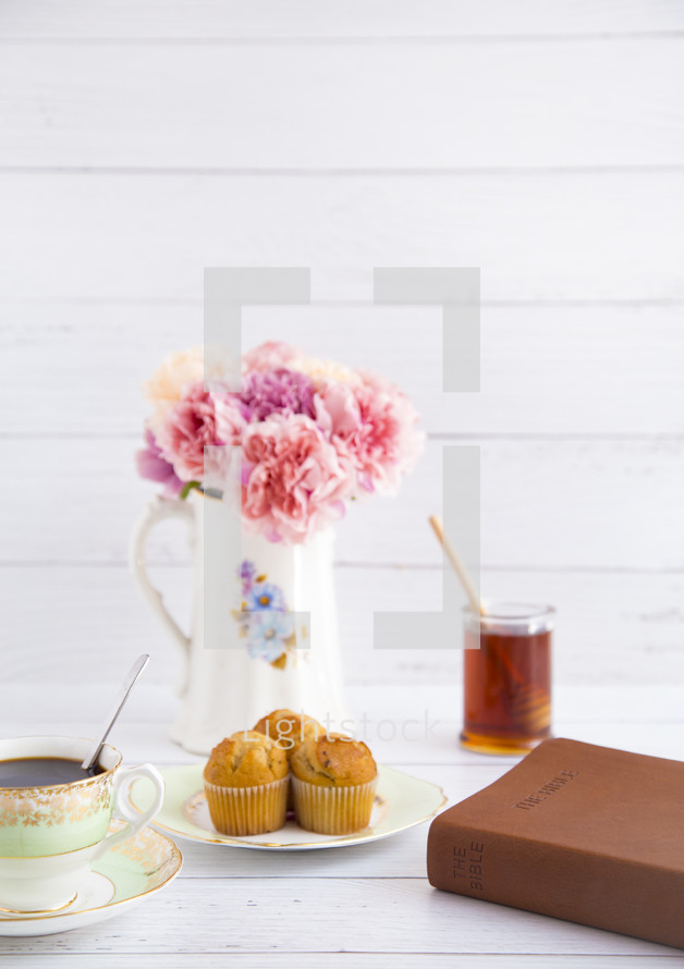 tea, muffins, and Bible on a table 