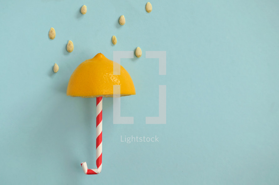 Conceptual Rain and Umbrella from Lemon and Paper Straw