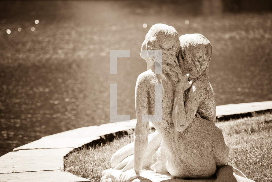 stone statue of women hugging 