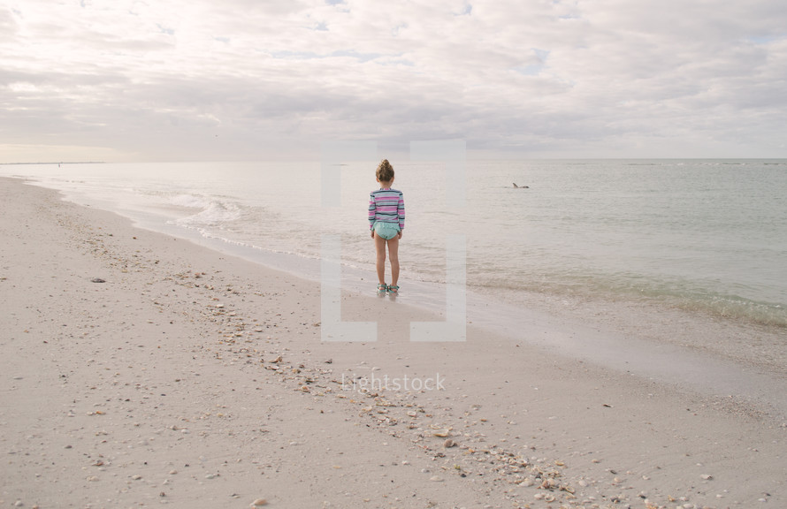 child standing on a beach 