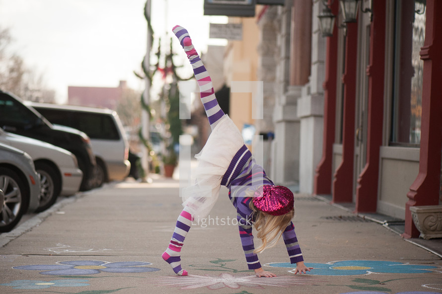 a girl child doing cartwheel 