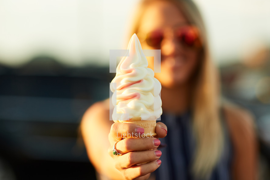 a woman holding an ice cream cone