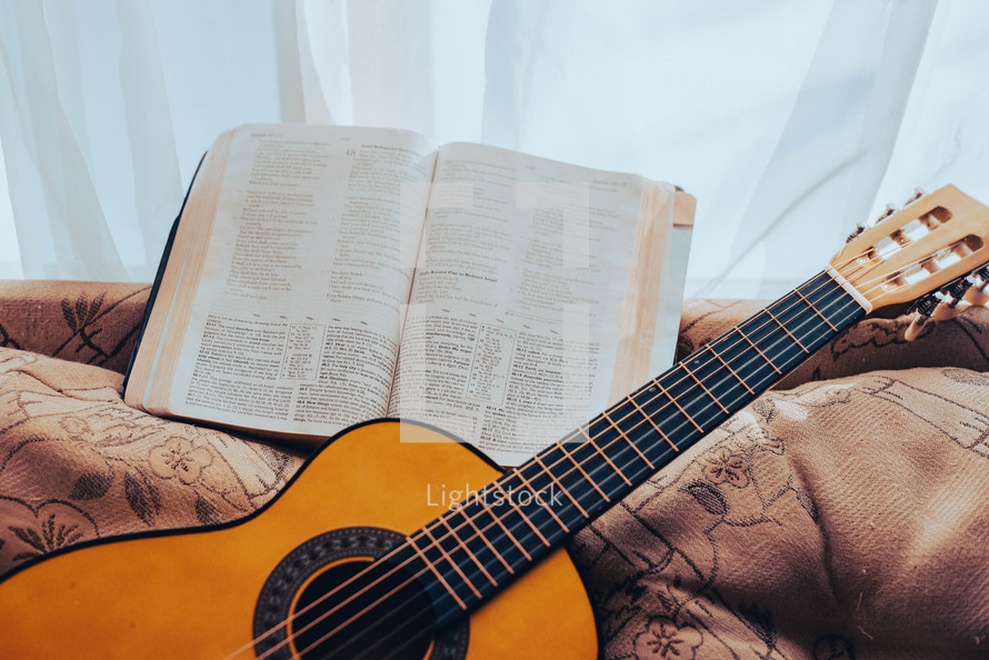 open Bible and acoustic guitar 