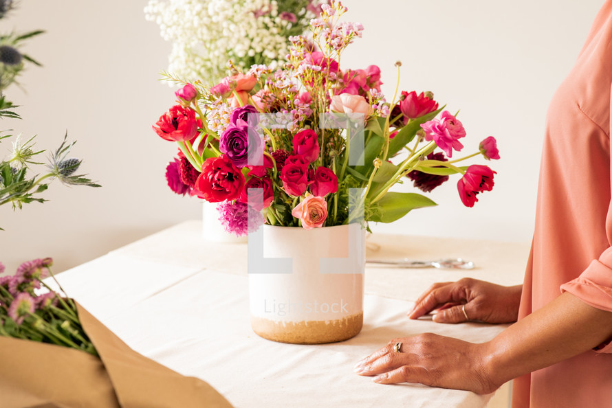 a mother arranging a bouquet of flowers 