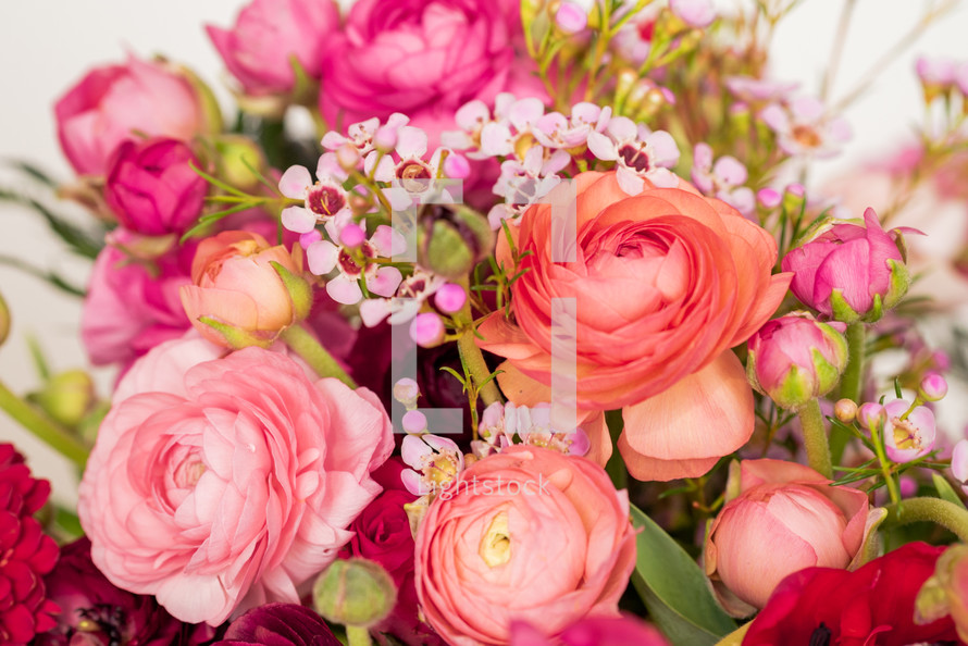 closeup of flower arrangement in peach, pink, and coral 
