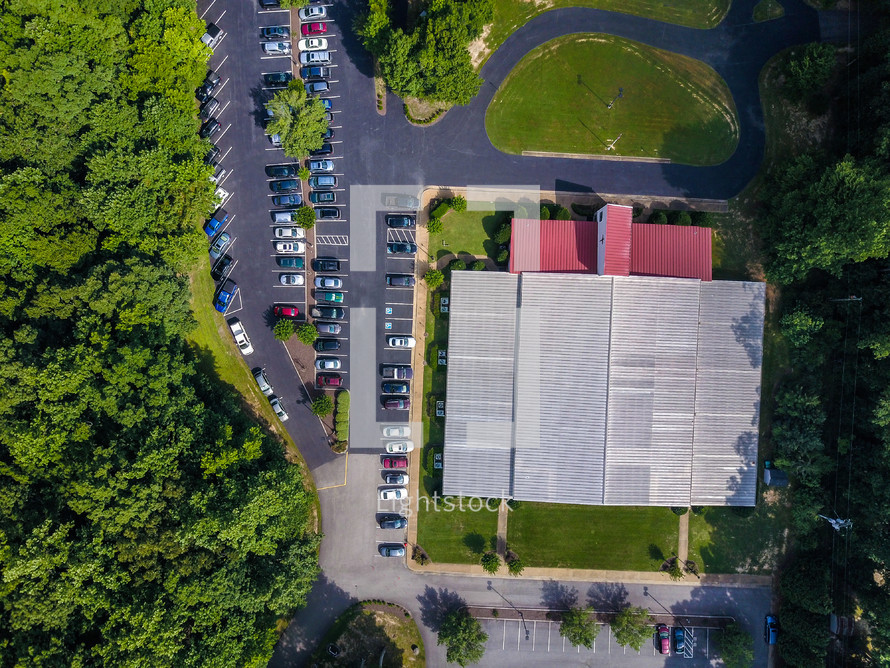 aerial view over a church and parking lot 
