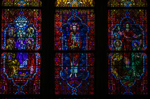 Depictions of Jesus and Mary on three stained glass windows.