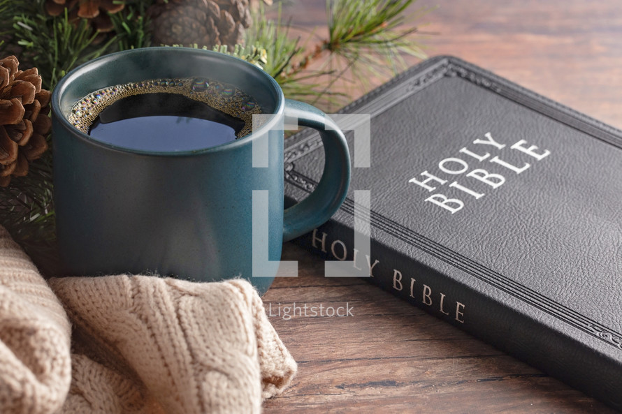 coffee cup and sweater with pine branches and Bible 
